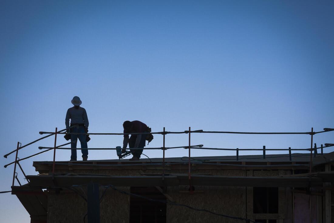 two workers fixing the roof