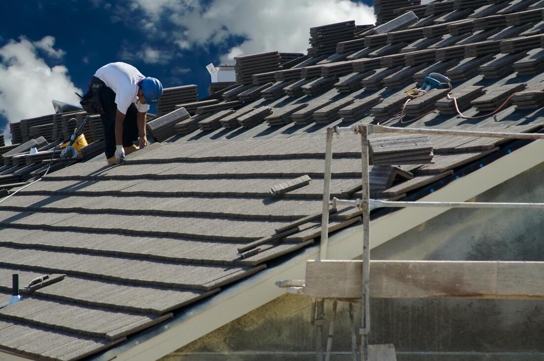 man installing the roof tile